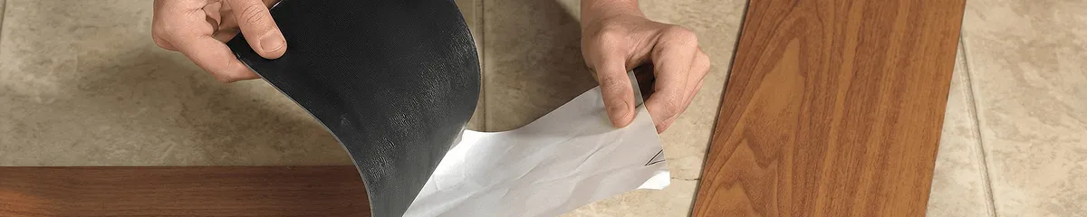 A professional installing vinyl flooring in Birmingham, AL